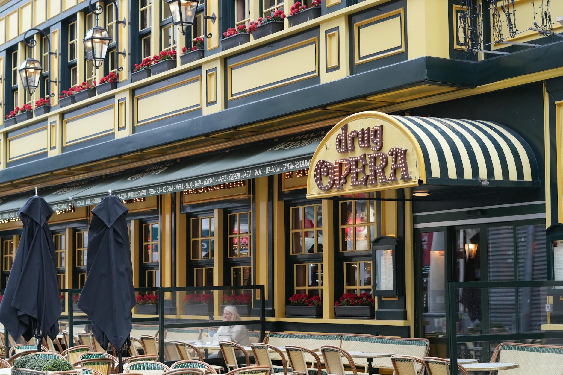 Outdoor café terrace in Brussels with tables and chairs on a sunny European street