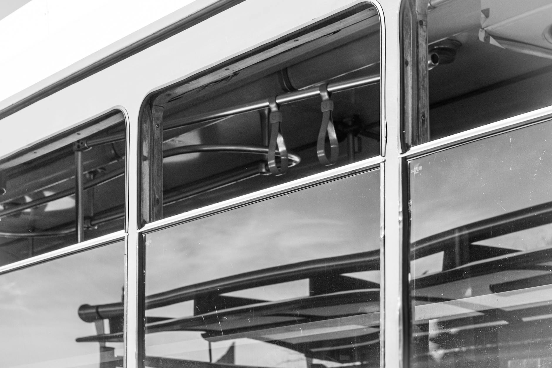 A public transport bus on a city street picking up passengers