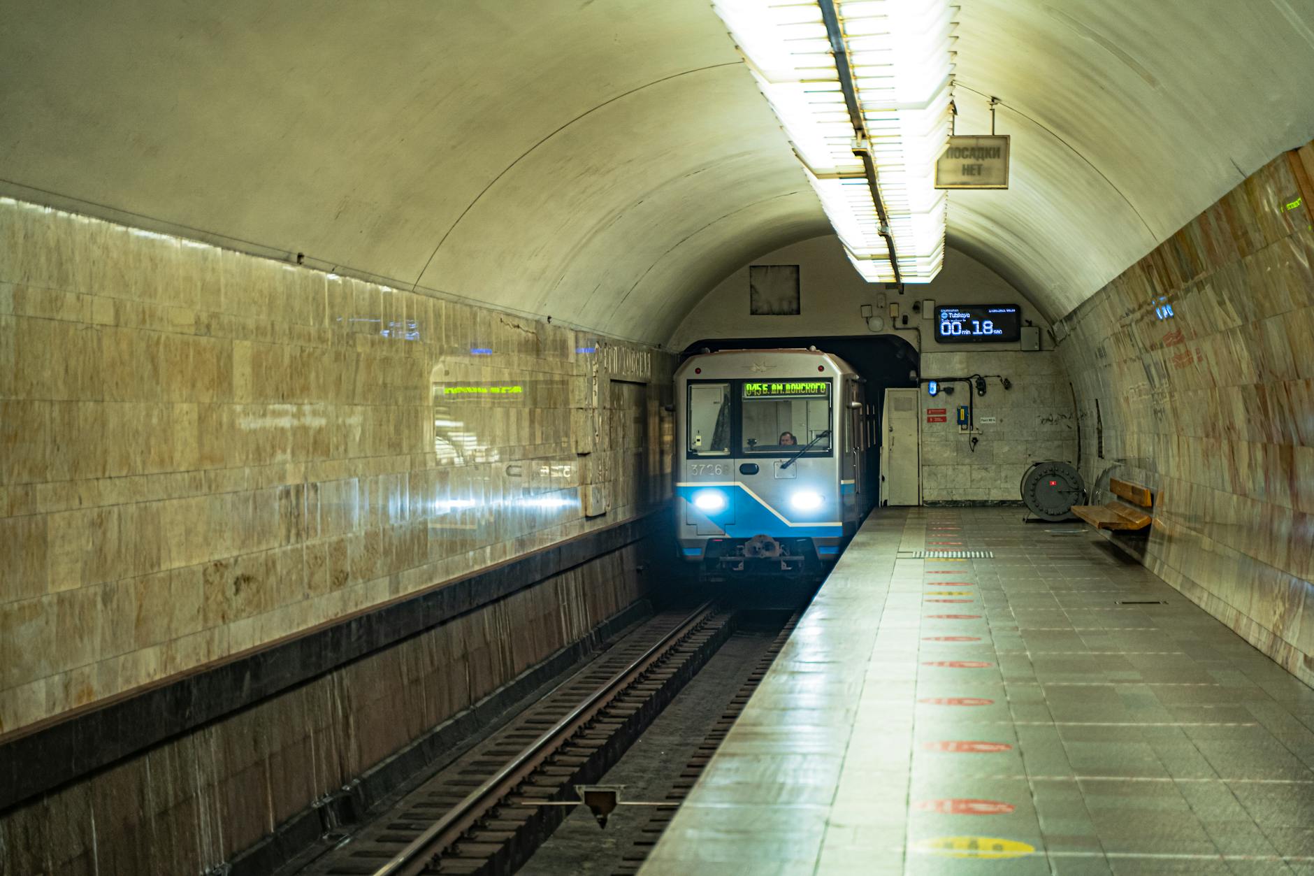 Interior of a metro station with platform and tunnel showing modern underground transport