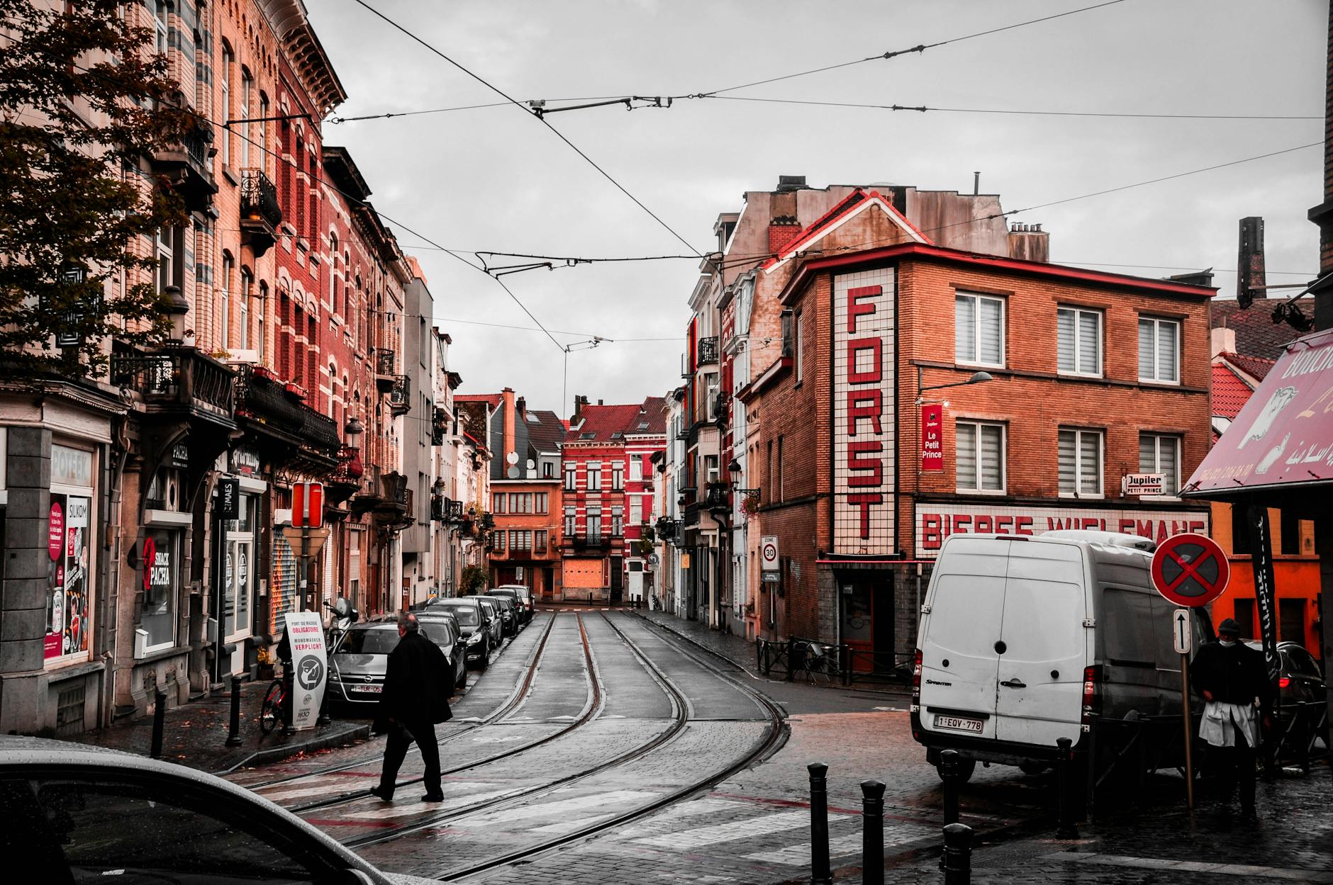 A Brussels tram travelling through city streets alongside historic buildings